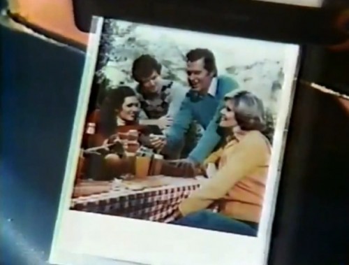 A screengrab of a picture of people looking at a picture. Mind blown? (Polaroid One Step commercial, 1978)