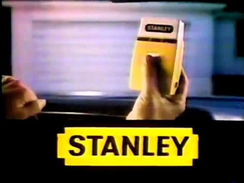 A nice, inconspicuous bright yellow & white garage door opener for your car. (Stanley commercial, 1978)